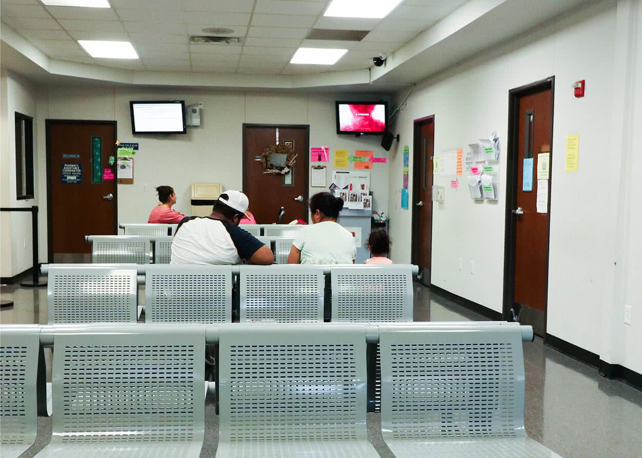 Patients in the waiting room filling out their financial assistance paperwork.